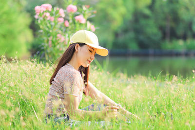 Young woman wearing hat on field