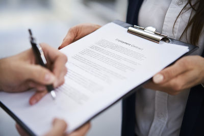 Close-up of employee signing employment contract