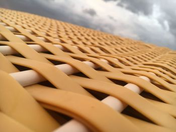 Close-up of wicker basket on beach against sky