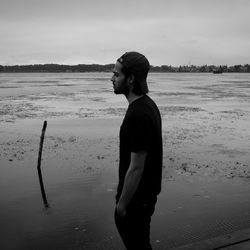 Side view of man standing on beach