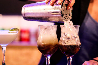 Close-up of hand pouring wine in glass