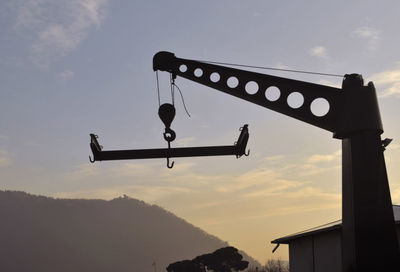 Low angle view of silhouette bridge against sky at sunset