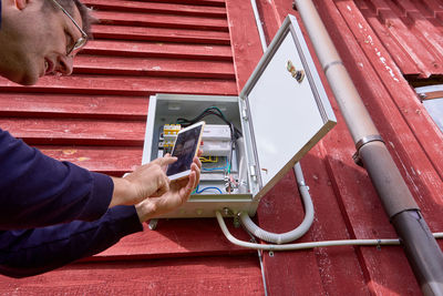 Low section of man using mobile phone