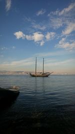 Sailboats sailing in sea against sky during sunset