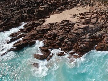 Aerial view of rock formation by sea