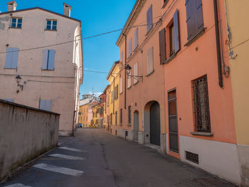 Ancient colorful building facade in a narrow street in italy.