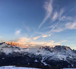 Scenic view of snow mountains against blue sky