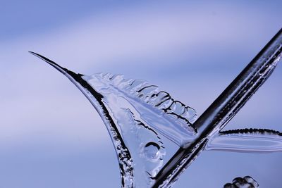 Low angle view of icicles against clear sky