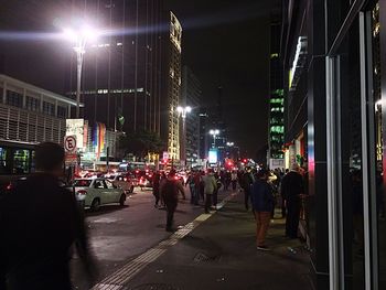 People on city street at night