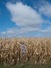 Hay bales on field against sky