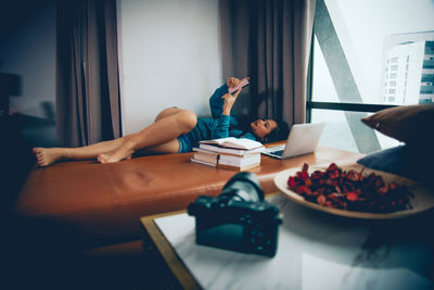 Midsection of man using mobile phone on table