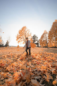 Full length of person standing on field during autumn