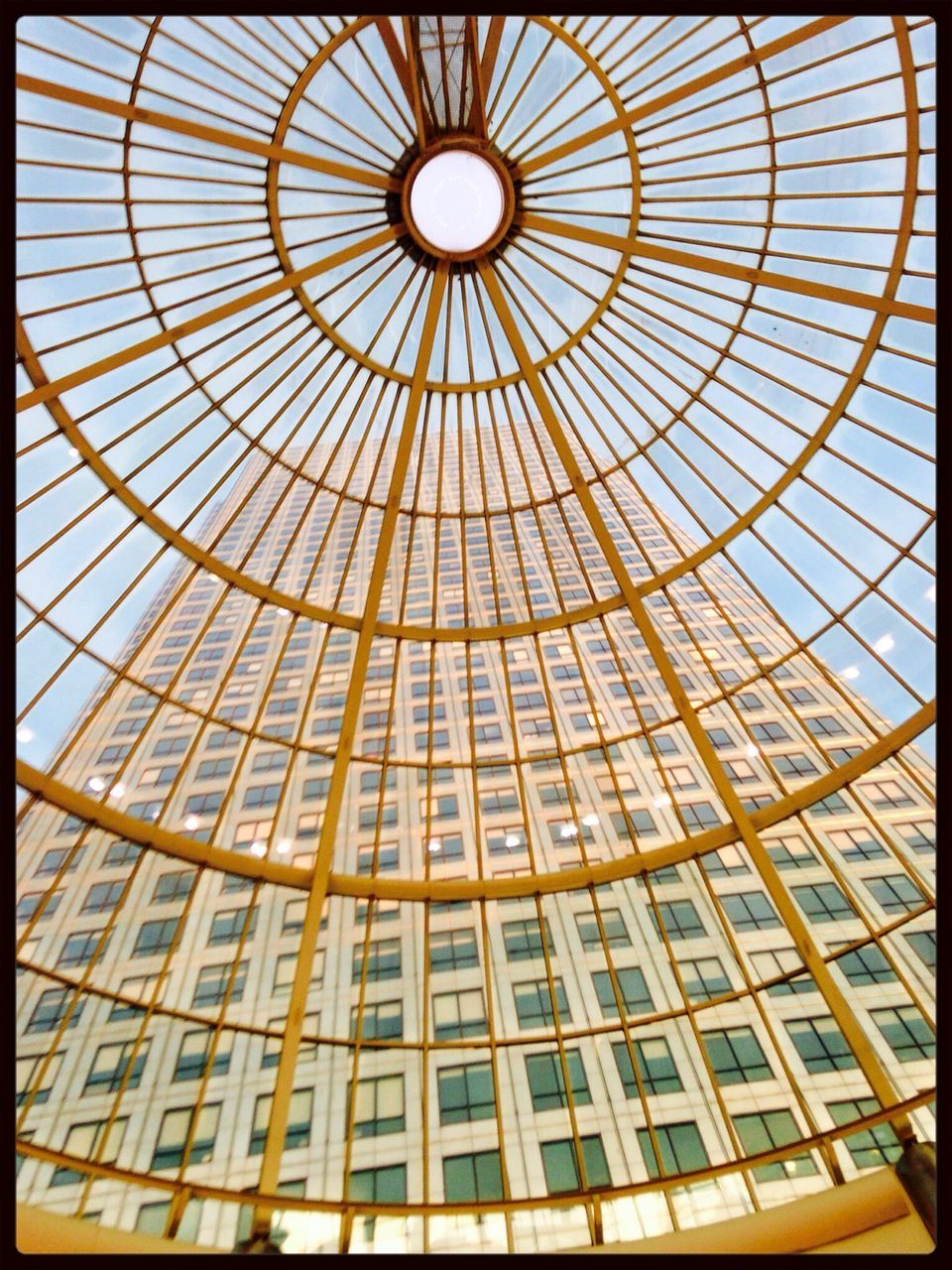 architecture, indoors, built structure, ceiling, low angle view, glass - material, pattern, architectural feature, modern, skylight, window, building exterior, design, geometric shape, transparent, dome, building, repetition, no people, shape