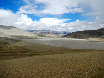 Scenic view of mountains against cloudy sky