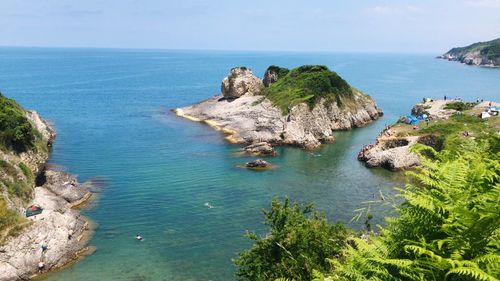 High angle view of rocks and sea against sky