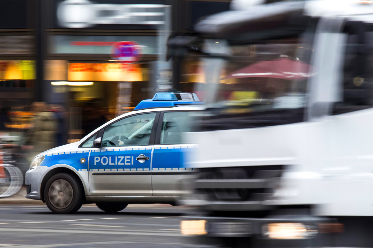 BLURRED MOTION OF VINTAGE CAR ON BUS