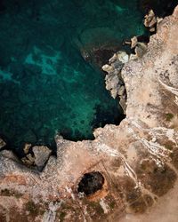 High angle view of rocks in sea