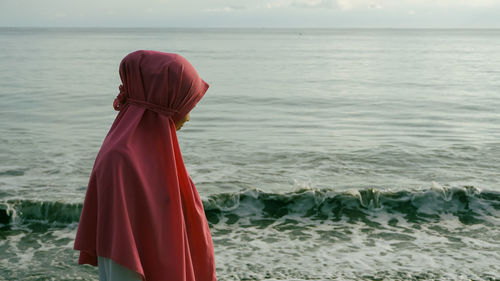 Rear view women with hijab on the beach