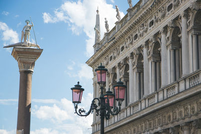 Low angle view of street light against building