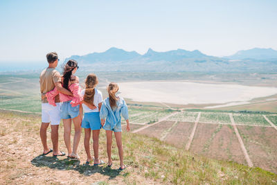 Rear view of friends standing on mountain