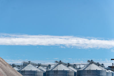 Section of silos against blue sky