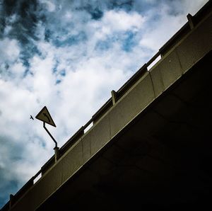 Low angle view of building against cloudy sky