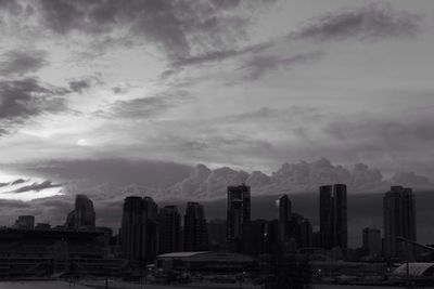 Cityscape against cloudy sky