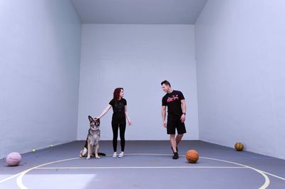 People with dog against wall