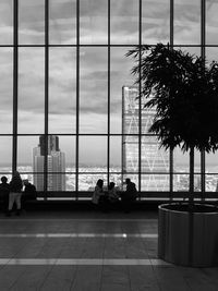 People sitting by window at airport
