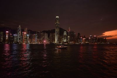 Illuminated buildings in city at night in hong kong 