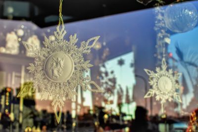 Close-up of christmas decorations hanging against blurred background