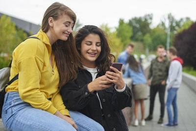 Portrait of young woman using mobile phone