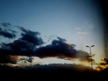 Low angle view of street light against sky during sunset