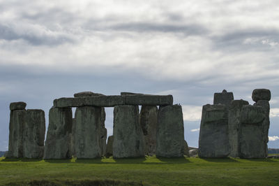 Built structure on field against cloudy sky