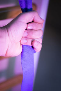 Cropped hand holding strap in gym