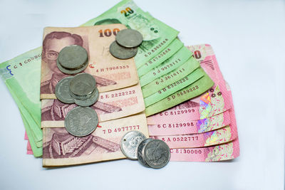 High angle view of coins on white background