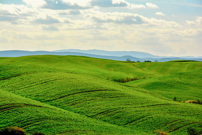 Scenic view of landscape against cloudy sky