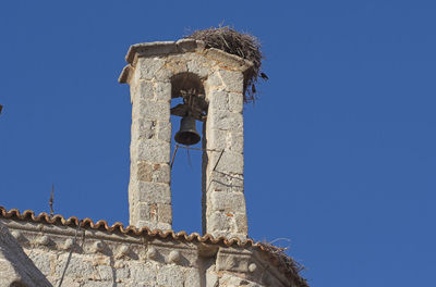 Low angle view of old building against clear blue sky