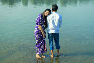 Friends standing in lake