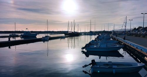 Boats in marina at sunset