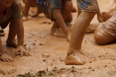 Low section of people standing on mud