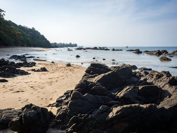 Rocks on beach against sky