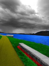 Scenic view of field against cloudy sky