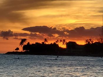 Scenic view of sea against orange sky