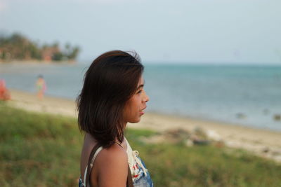 Woman looking away at beach