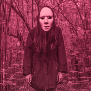 Portrait of woman standing against bare trees