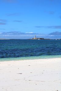 Scenic view of sea against blue sky