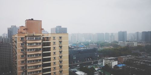 High angle view of buildings against clear sky
