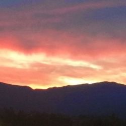 Scenic view of mountains against sky during sunset