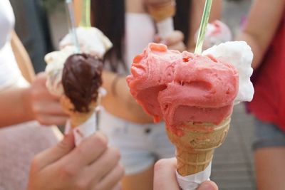 Close-up of hands holding ice cream cone